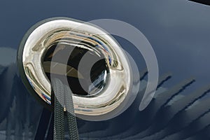 Closeup shot of black mooring rope through a round yacht window