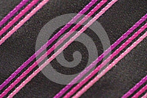 Closeup shot of a black tie with purple stripes