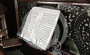 Closeup shot of the black and white music sheet on the piano