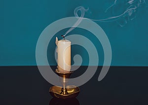 Closeup shot of a blown-out candle with smoke