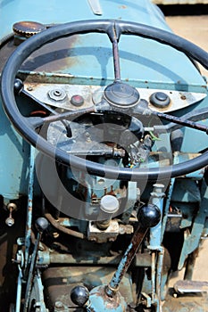 Closeup shot of a blue tractor wheel and its\' controls