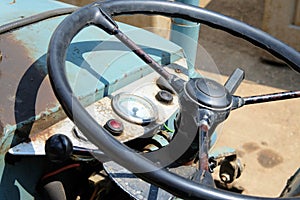 Closeup shot of a blue tractor wheel and its\' controls