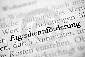 Closeup shot from the book of the word 'Eigenheimforderung' translated as home ownership
