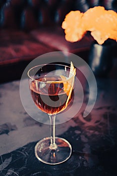 Closeup shot of a Boulevardier cocktail with an orange twist as garnish