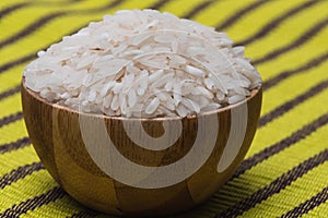 Closeup shot of a bowl of rice on a wooden surface