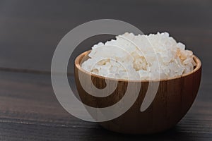 Closeup shot of a bowl of rice on a wooden surface