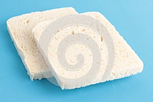 Closeup shot of bread without rind on a blue surface