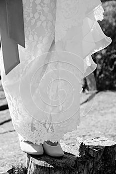 Closeup shot of a bride's feet on a stone