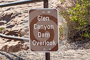 Closeup shot of a brown metal Glen Canyon Dam Overlook sign