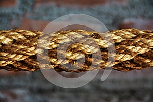 Closeup shot of a brown multilayered rope with a blurred background