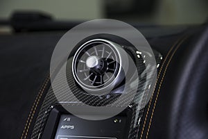Closeup shot of car aircon on a black dashboard in a car photo