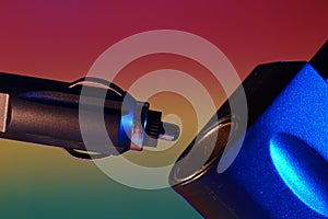 Closeup shot of a car cigarette lighter on a colorful background
