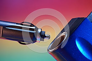 Closeup shot of a car cigarette lighter on a colorful background