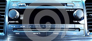 Closeup shot of a car electronic panel, showing the radio, CD player, Aux