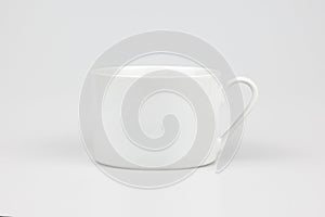 Closeup shot of a ceramic white mug isolated on the white background