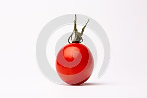 Closeup shot of a cherry tomato on a white background - perfect for a food blog