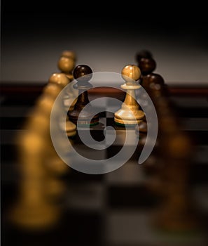 Closeup shot of chess figures on a chessboard with a blurred background