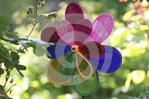 Closeup shot of a children's colorful toy wind turbine in a park