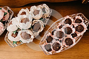Closeup shot of chocolate candies with nuts in decorative flower buds
