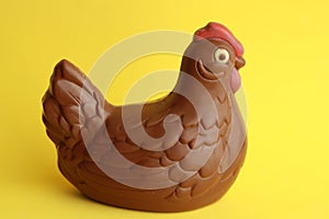 Closeup shot of a chocolate hen with a yellow background