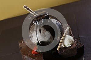 Closeup shot of chocolate souffle with a wafer on a brown background