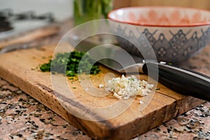 Closeup shot of chopped fresh garlic and parsley to prepare Provenzal