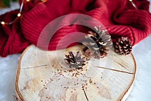 Closeup shot of Christmas tree bumps on a plate and red fabric on a table