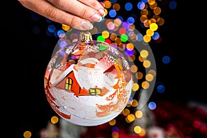 Closeup shot of a Christmas tree ornament with blurred lights in the background