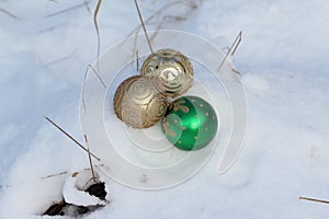 Closeup shot of Christmas tree ornaments on the snow