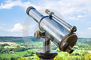 Closeup shot of a city telescope on a scenic natural background