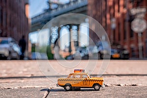 Closeup shot of a classic yellow taxi toy cab on a blurred background