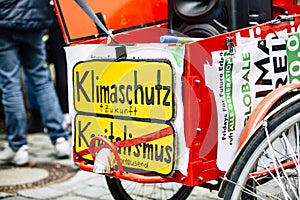 Closeup shot of a climate change strike posters on a bicycle written in German