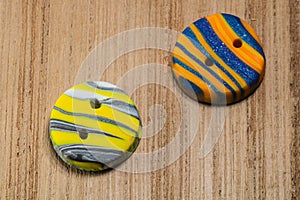 Closeup shot of colorful buttons put on a wooden surface