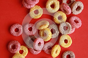 Closeup shot of colorful cereals on a red background