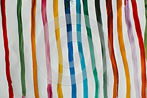 Closeup shot of colorful lines painted by watercolor on a white paper