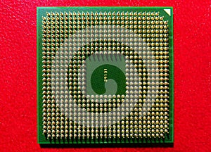 Closeup shot of Computer CPU (central processor unit) chip isolated on a red background