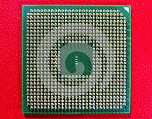 Closeup shot of Computer CPU (central processor unit) chip isolated on a red background