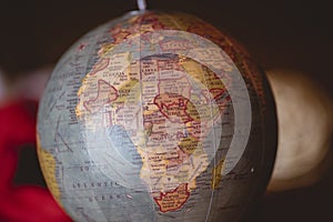 Closeup shot of countries on a desk globe with a blurred background