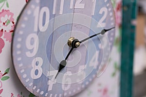 Closeup shot of a crafty design wall clock with a blurred background