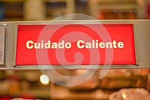 Closeup shot of Cuidado Caliente text with a bokeh background photo