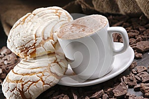 Closeup shot of a cup of latte coffee with sweet pastries