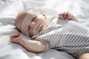 Closeup Shot Of Cute Lovely Newborn Baby Sleeping On Bed