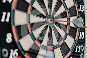 Closeup shot of a dartboard with a pin in the center bullseye- success concept