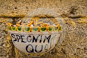 Closeup shot of a decorated ceramic ashtray on the wall in Sciacca old town, Sicily, Italy