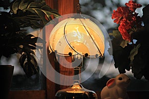 Closeup shot of a decorative illuminated vintage lamp on a bedside table