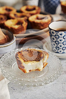 Closeup shot of delicious Pastel de Nata Vanilla pastries with espresso on a white table photo