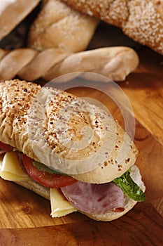 Closeup shot of a delicious sandwich with ham, cheese, tomatoes and lettuce