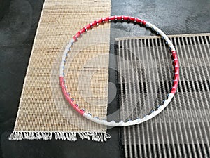 Closeup shot of a detachable hula hoop with massage balls on the carpet mats