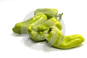 Closeup shot of digestible green peppers isolated on a white background