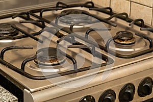 Closeup shot of a dirty gas stove in the kitchen